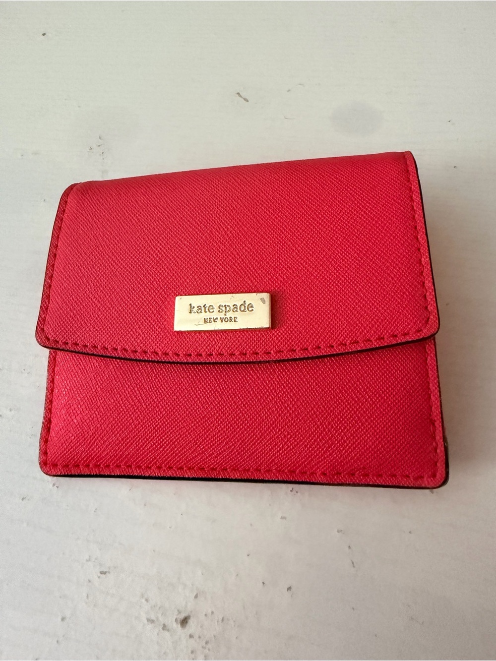 kate spade reddish orange leather small flap wallet with gold plaque